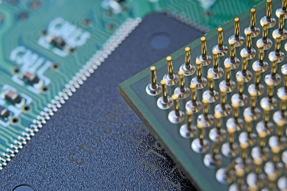 old computer processor with gold-plated legs, microcircuits on it, super macro photo